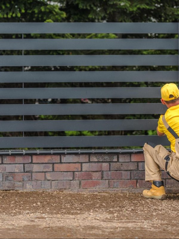Man installing a fence.