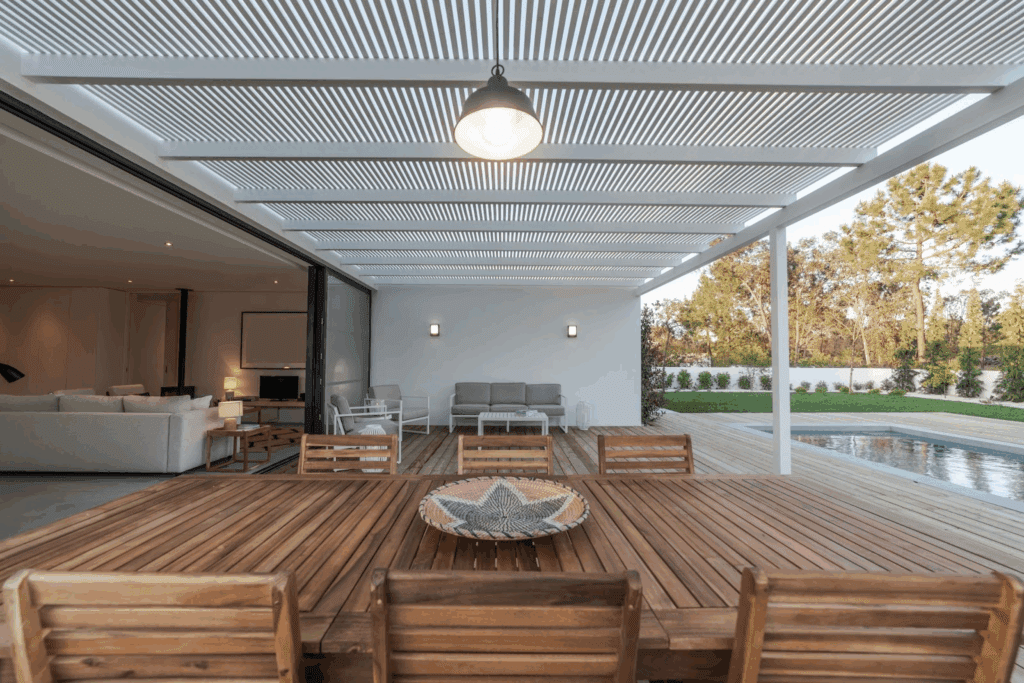 Modern home with a vinyl lattice patio cover overlooking a garden, swimming pool, and wooden deck for stylish outdoor living.