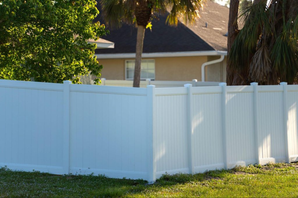 A white vinyl privacy fence covers the backyard for protection and seclusion.