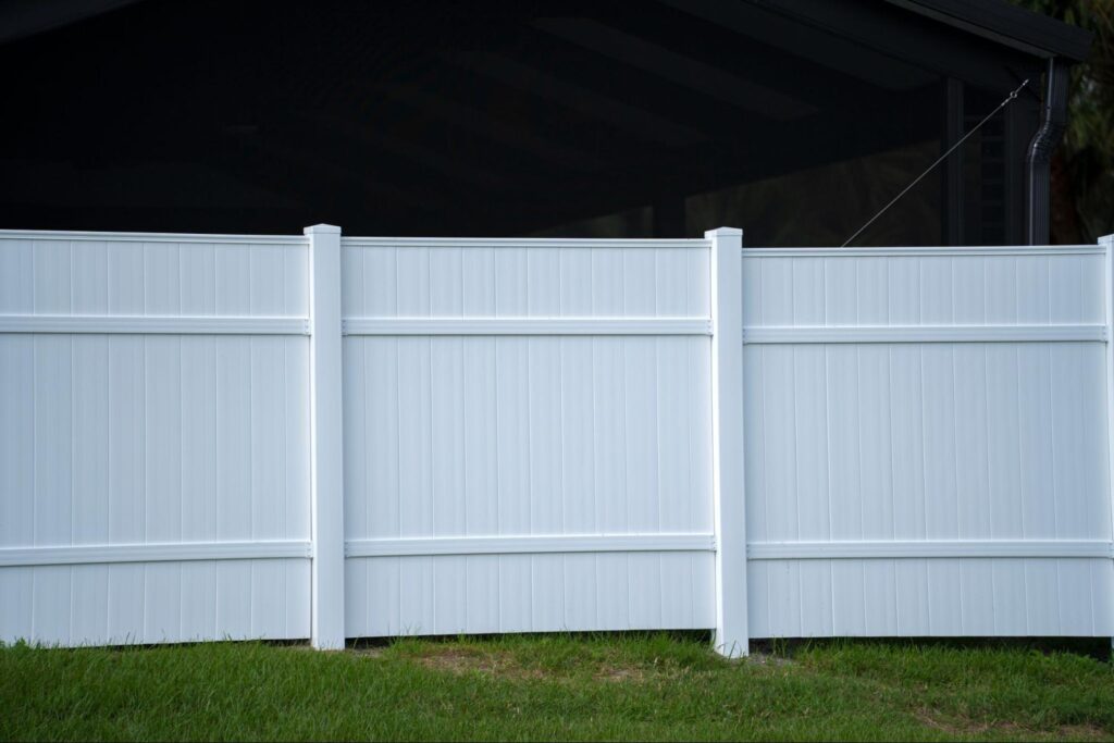 A front view of a white vinyl fence.