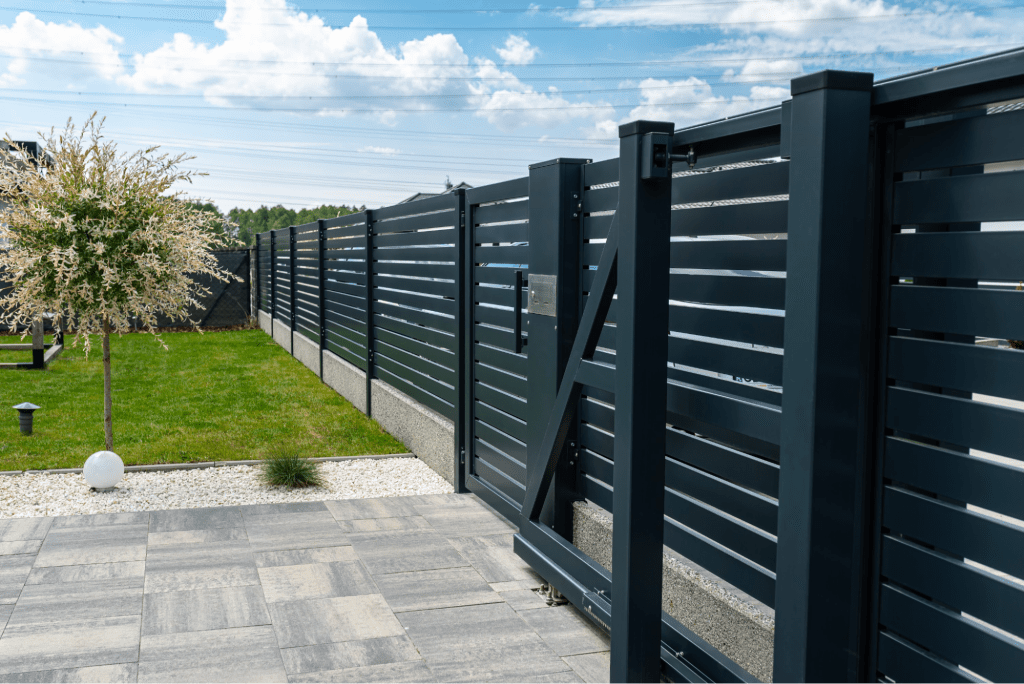A black painted vinyl fence.
